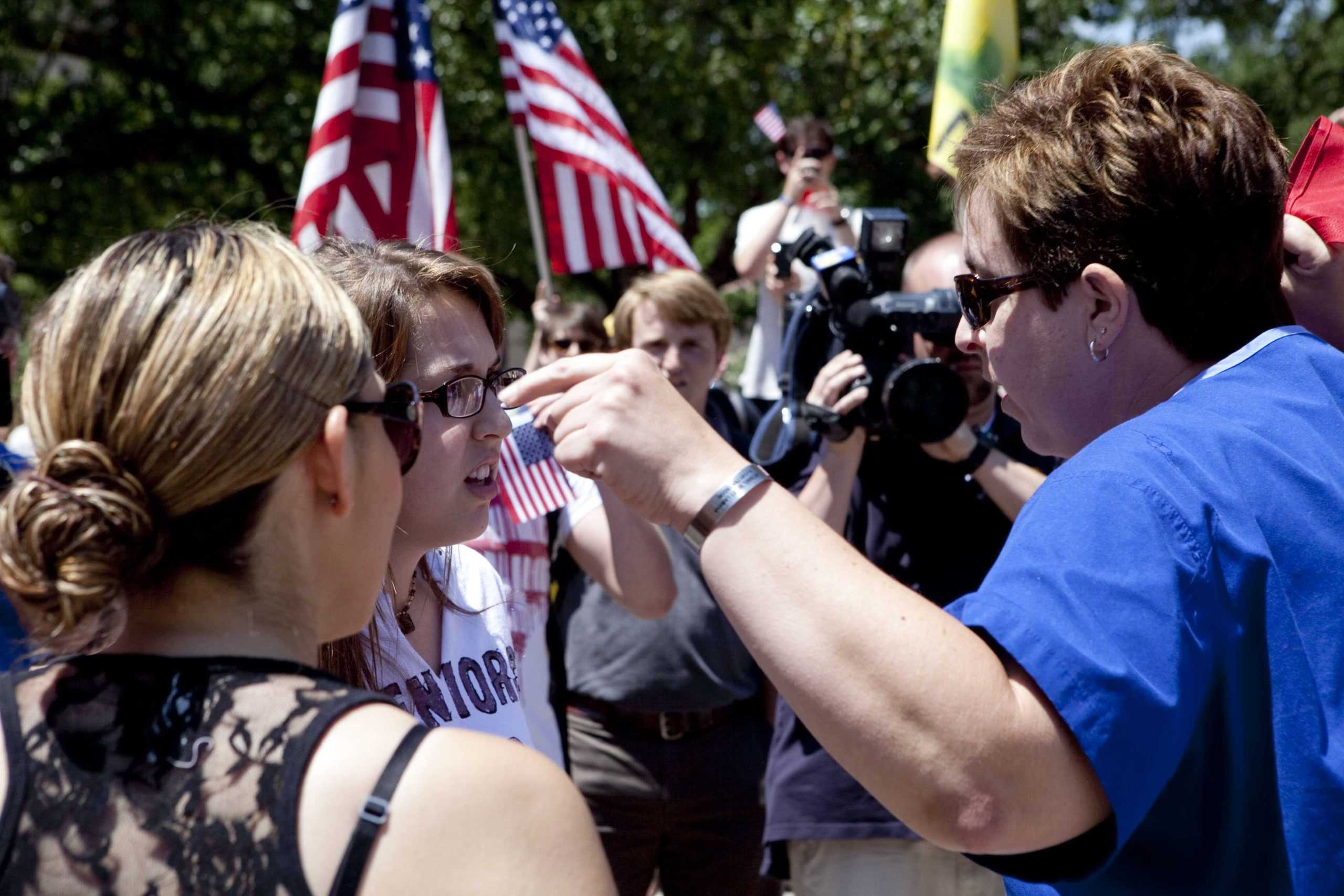 Angry crowd swarms for scheduled flag burning