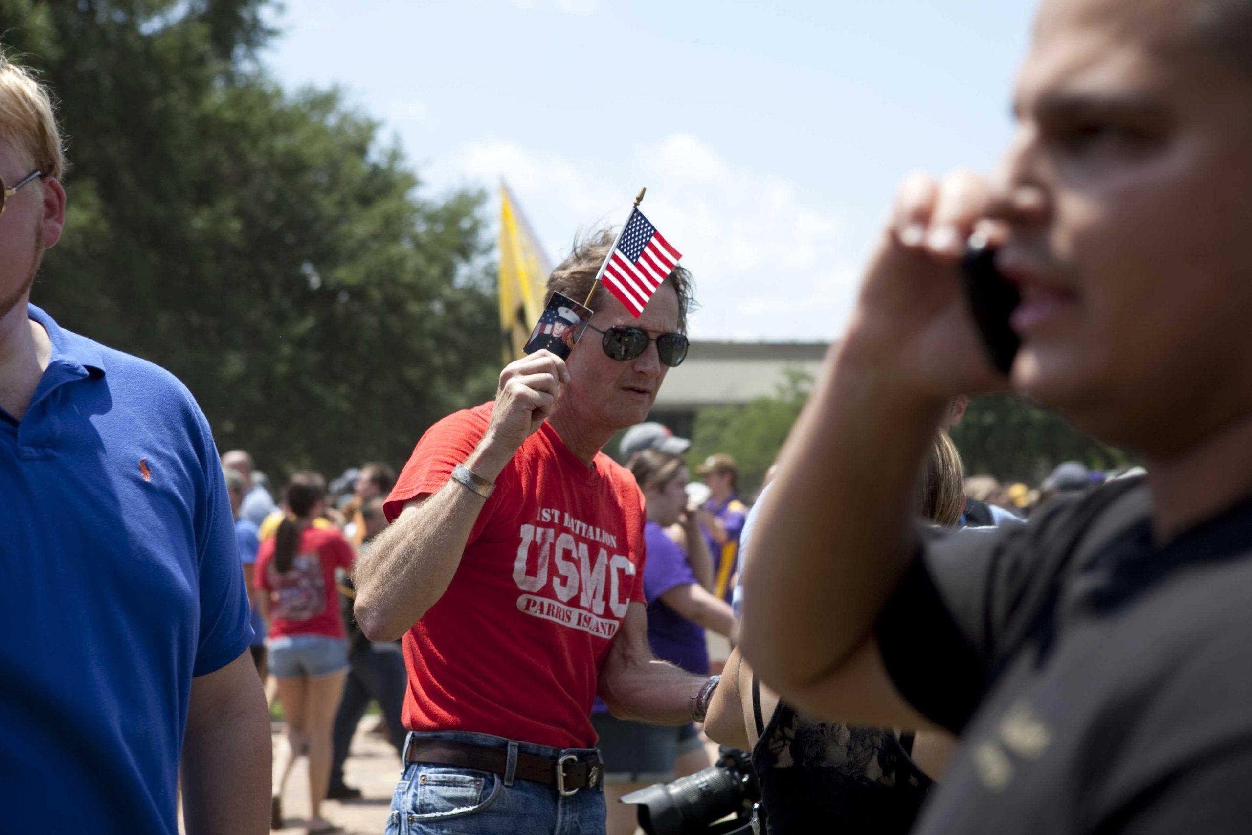 Angry crowd swarms for scheduled flag burning