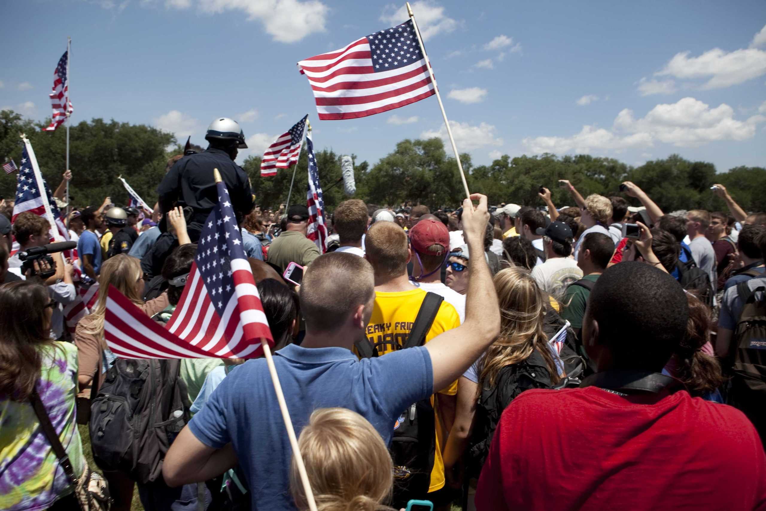 Angry crowd swarms for scheduled flag burning