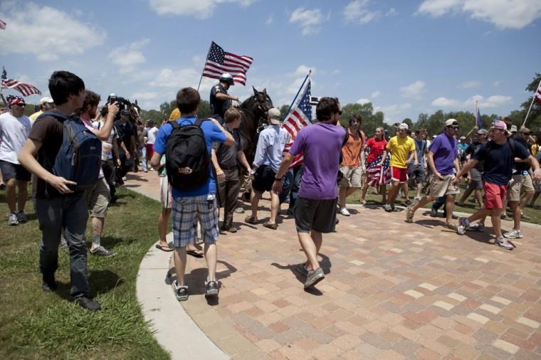 Angry crowd swarms for scheduled flag burning