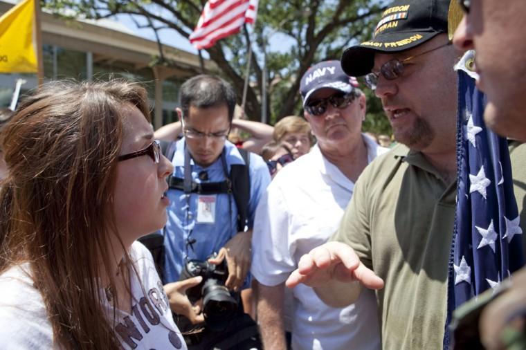 Angry crowd swarms for scheduled flag burning