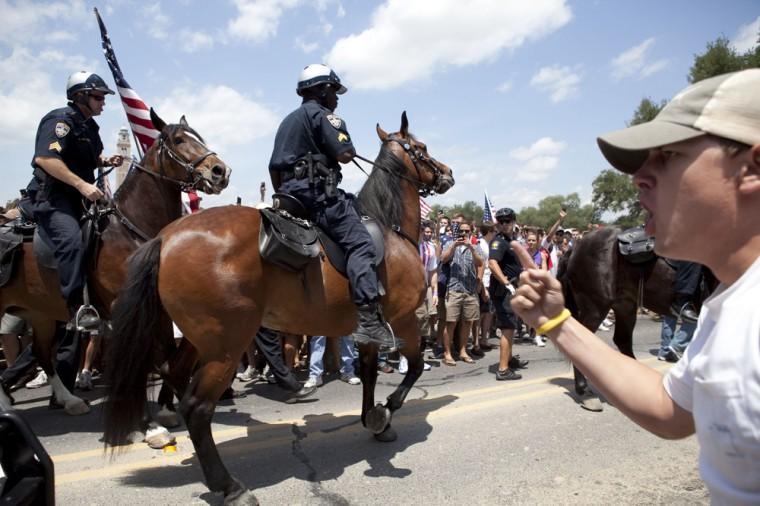 Angry crowd swarms for scheduled flag burning