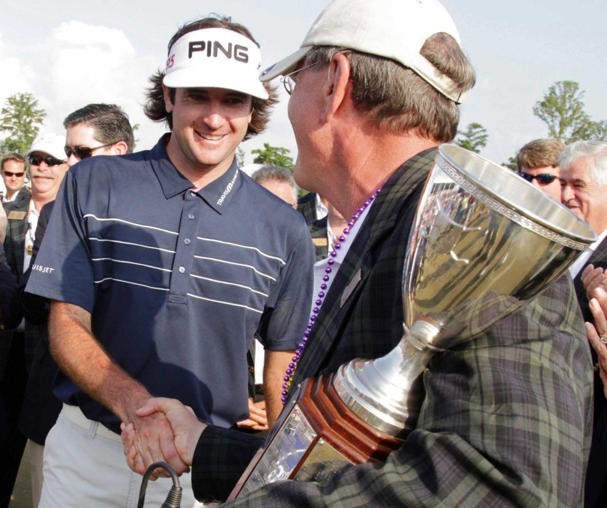 Bubba Watson, left, shakes hands with Bill Reinhardt on Sunday after winning the Zurich Classic golf tournament in Avondale, La.