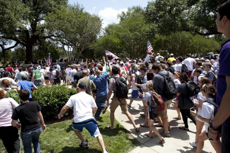 Angry crowd swarms for scheduled flag burning