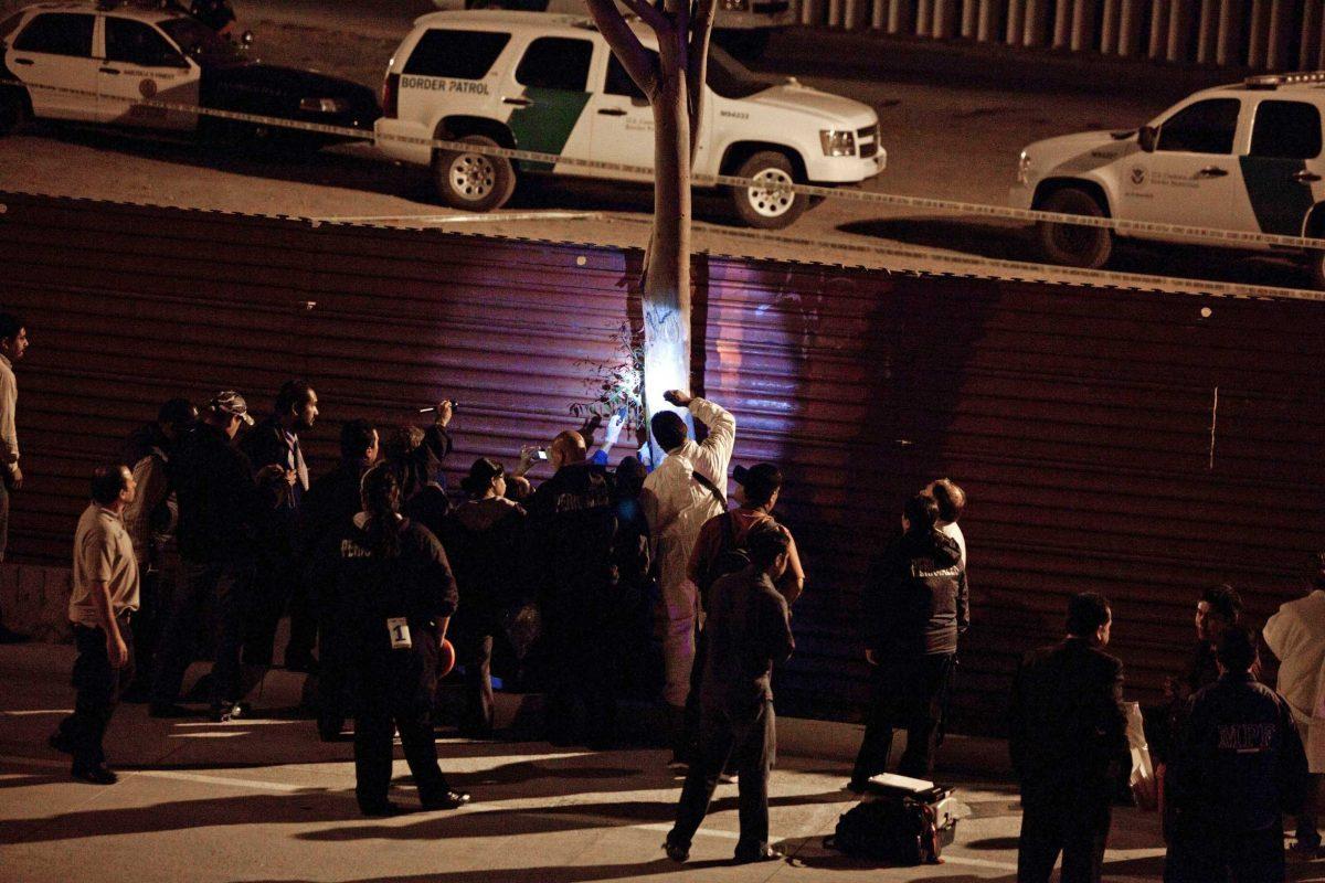 Mexican police and forensic experts examine the scene after a US border patrol agent shot and killed a man at the US-Mexico border in Tijuana, Mexico, late Tuesday June 21, 2011. Two men, presumably Mexican, assaulted two Border Patrol agents after crossing the border illegally about one mile west of San Diego's San Ysidro port of entry, a Border Patrol spokesman said. Tijuana police identified the victim as Jose Alfredo Yanez, 40.