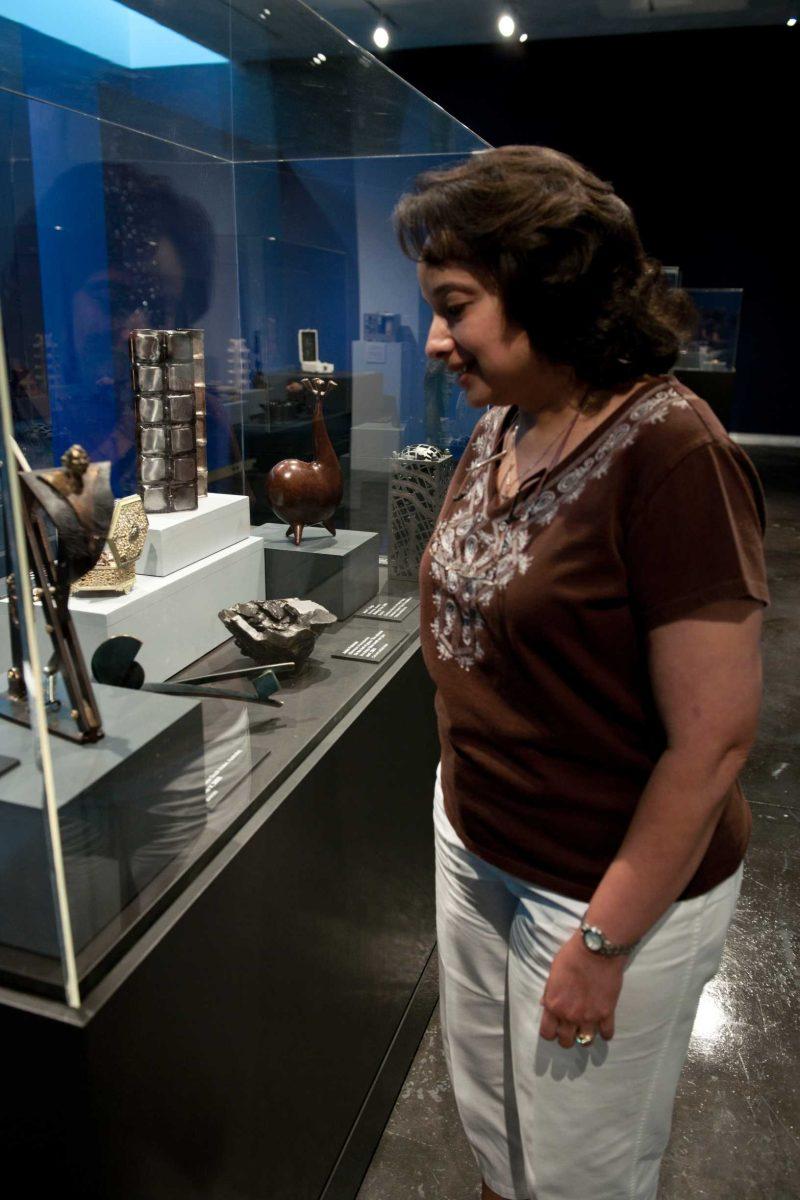 Rene&#233; Payton, LSU Museum of Art marketing director, examines works Wednesday in the 10th &#8220;International Shoebox Sculpture Exhibition.&#8221;