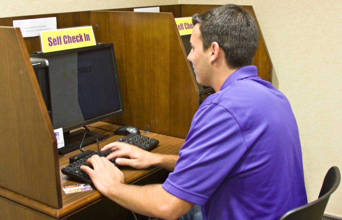 Mason Kent, biology sophomore, checks into the Student Health Center on Monday. The SHC is revamping its management system, implementing an electronic system.