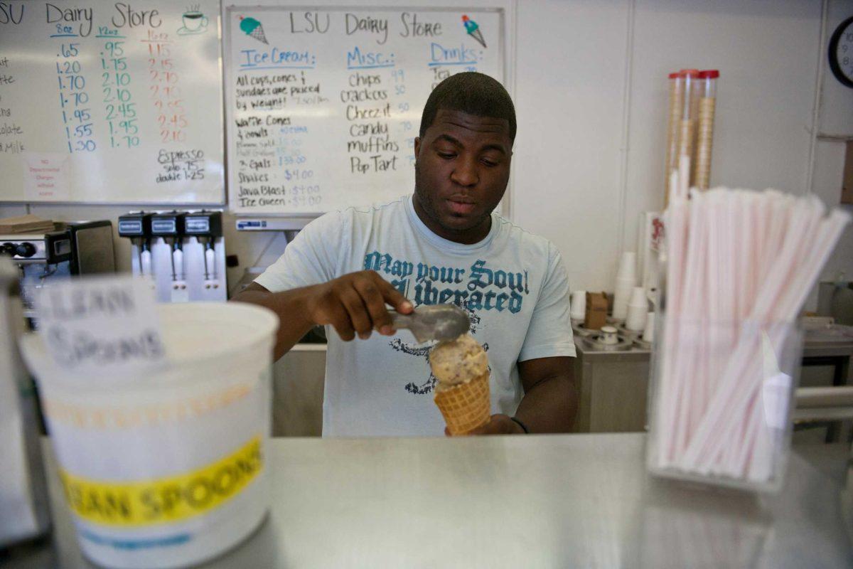 LSU Dairy Store employee Brandon Snerling scoops ice cream for a customer Monday. The Dairy Store, located on the south end of the Dairy Science Building, is planning future renovations, as well as a possible branch in the Student Union.