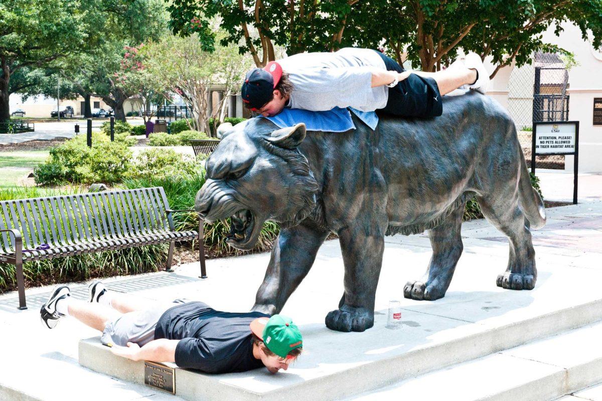 LSU sophomore linebacker D.J. Welter, left, and sophomore center Cameron Fordham demonstrate the Internet sensation &#8220;planking&#8221; Wednesday near Mike the Tiger&#8217;s cage.