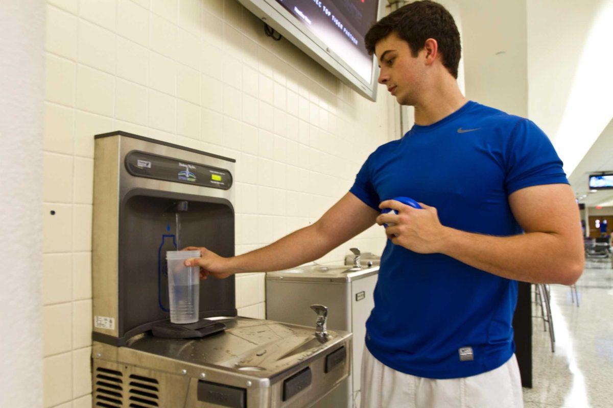 Jeremy Lee, chemical engineering senior, fills up his water bottle using the new EcoFriendly water fountain located in the UREC on Thursday.