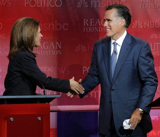 Republican presidential candidates former Massachusetts Gov. Mitt Romney, right, and Rep. Michele Bachmann, R-Minn., shake hands Wednesday after a Republican presidential candidate debate.