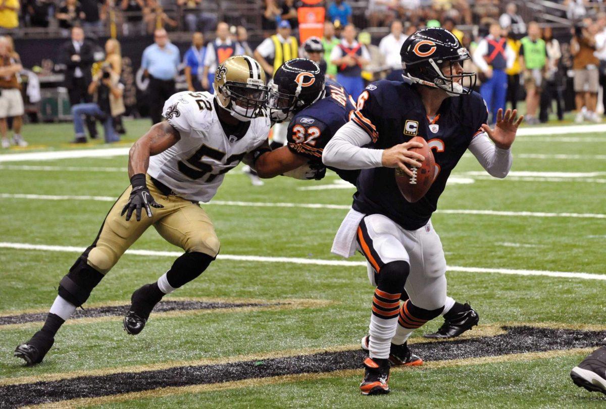 Bears quarterback Jay Cutler (6) runs in the end zone as Bears running back Kahlil Bell (32) blocks Saints outside linebacker Jonathan Casillas (52) during the game Sunday.