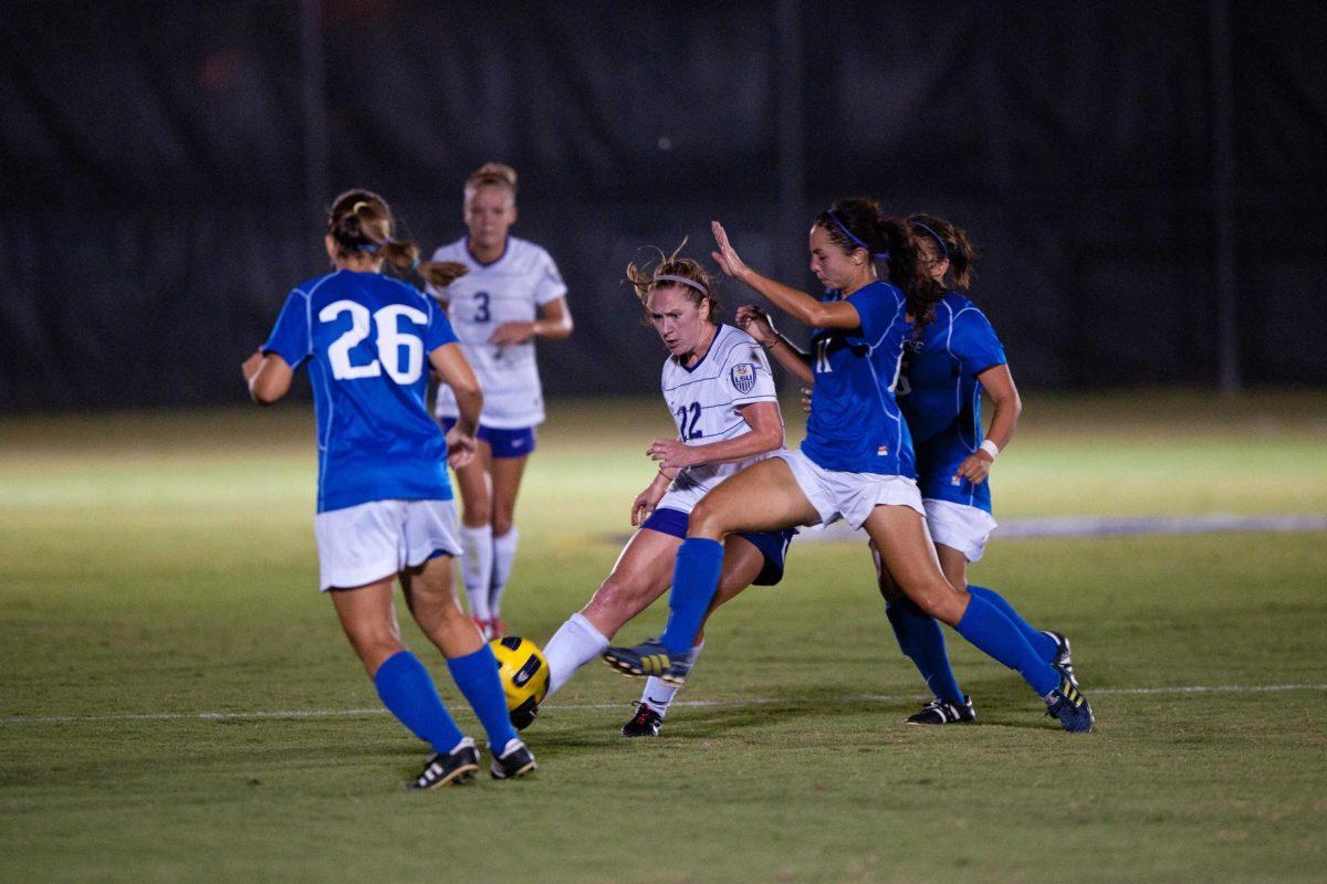 LSU Senior midfielder/defender Kellie Murphy maneuvers thorugh a crowd of Mcneese State defenders. The Tigers would go on to win 1-0.