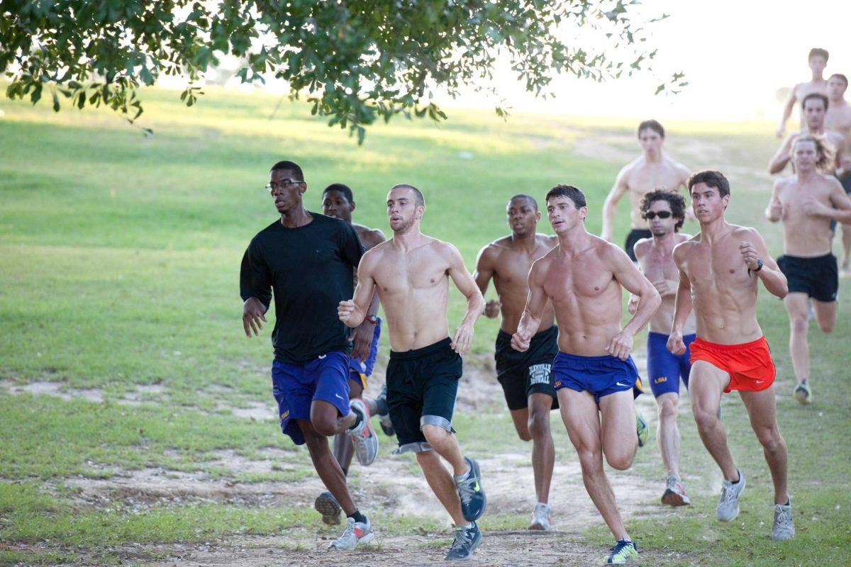 The men&#8217;s cross country team practices Monday evening at Highland Road Park.