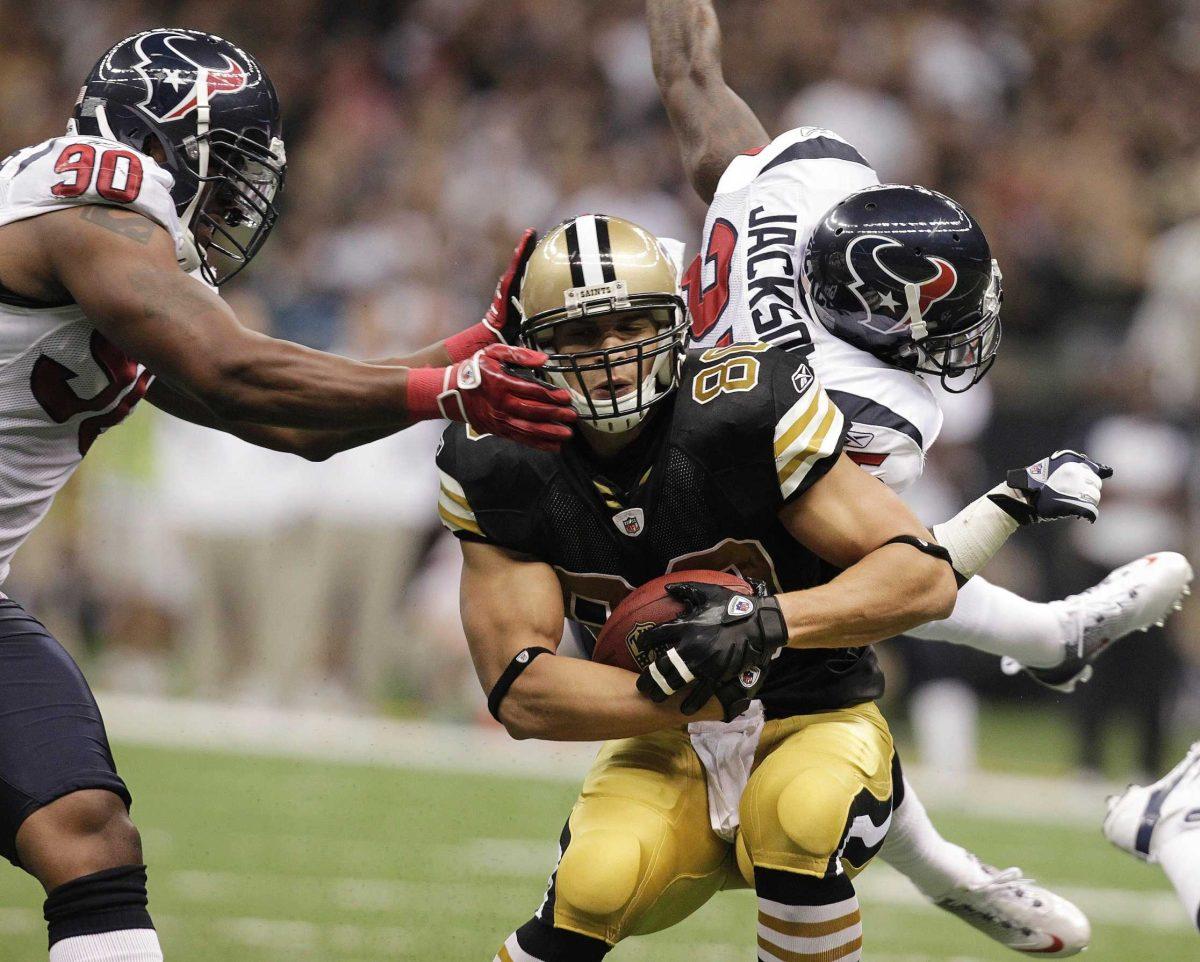 New Orleans Saints tight end Jimmy Graham (80) runs as Houston Texans outside linebacker Mario Williams (90) prepares to takcle Graham on Sunday.