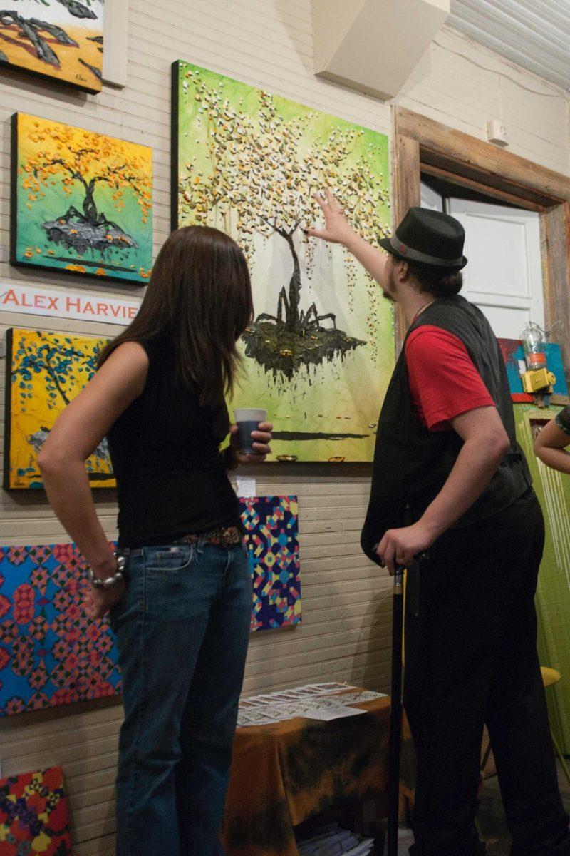 Patrons admire art Friday at Stabbed in the Art, which is held the first Friday of every month at Tiger District.