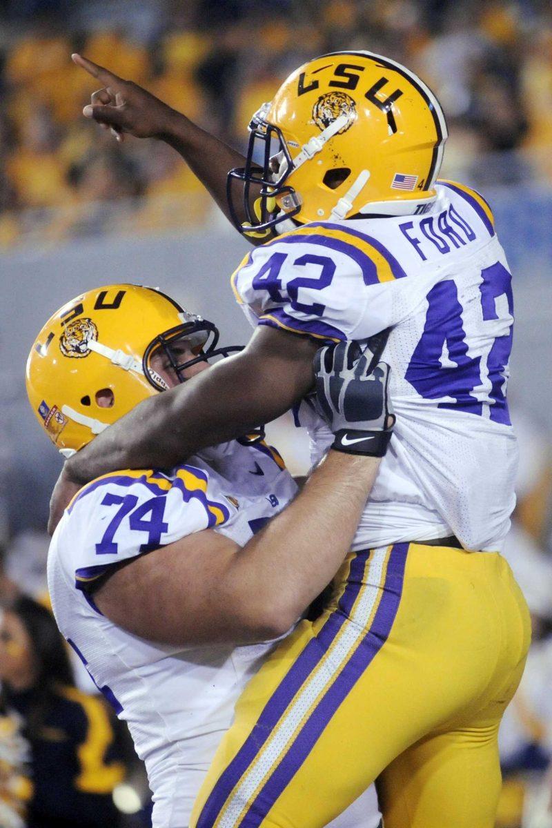 LSU running back Michael Ford celebrates a touchdown with offensive lineman Josh Williford on Saturday during the fourth quarter of LSU&#8217;s 47-21 win over West Virginia.