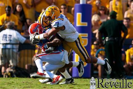 Sophomore cornerback Tyrann Mathieu (7) shares a tackle of a Florida player in the third quarter Saturday.