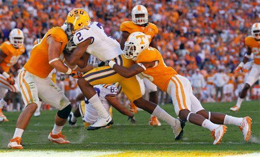 LSU wide receiver Rueben Randle (2) scores a touchdown on a 5-yard pass play as Tennessee defenders Austin Johnson, left, and Marsalis Teague, right, try to stop him in the second quarter of an NCAA college football game on Saturday, Oct. 15, 2011 in Knoxville, Tenn.