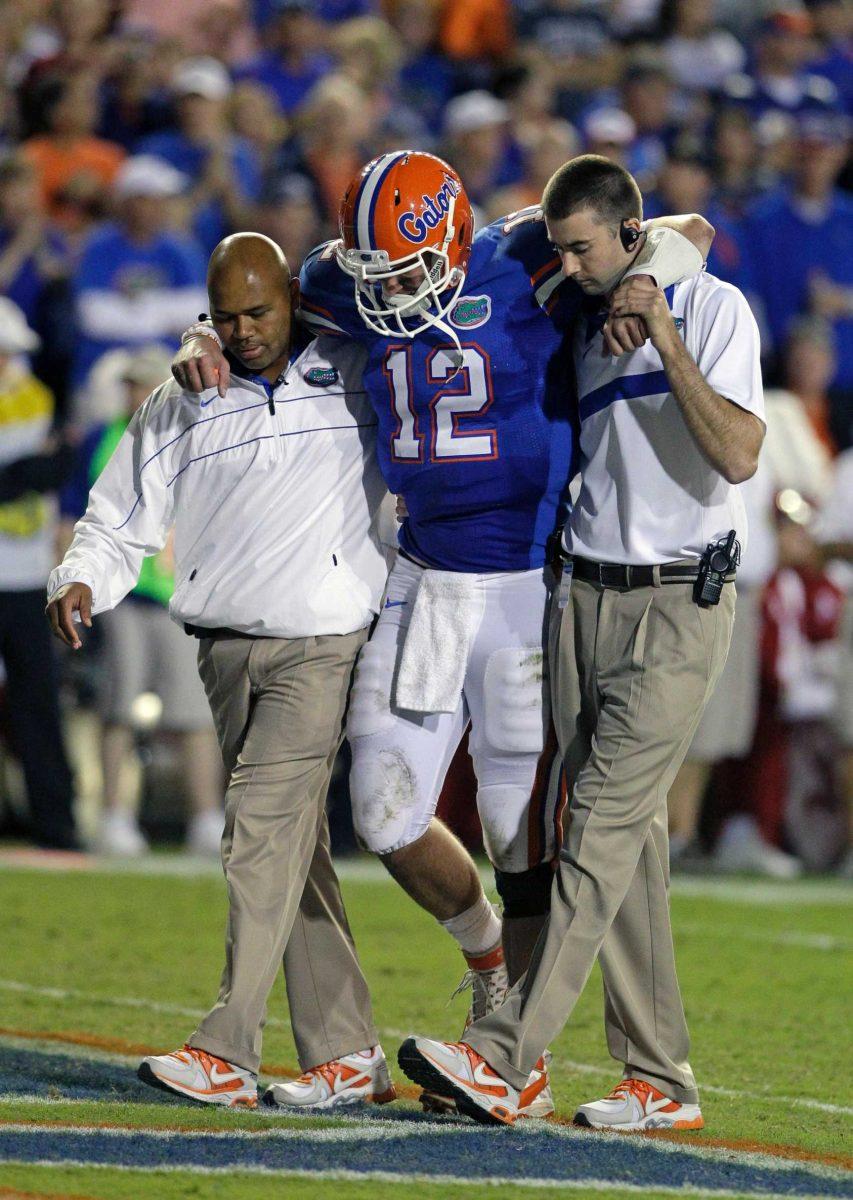 Florida quarterback John Brantley (12) is helped off the field Oct. 1 after he was injured late in the second quarter of an NCAA football game against Alabama.