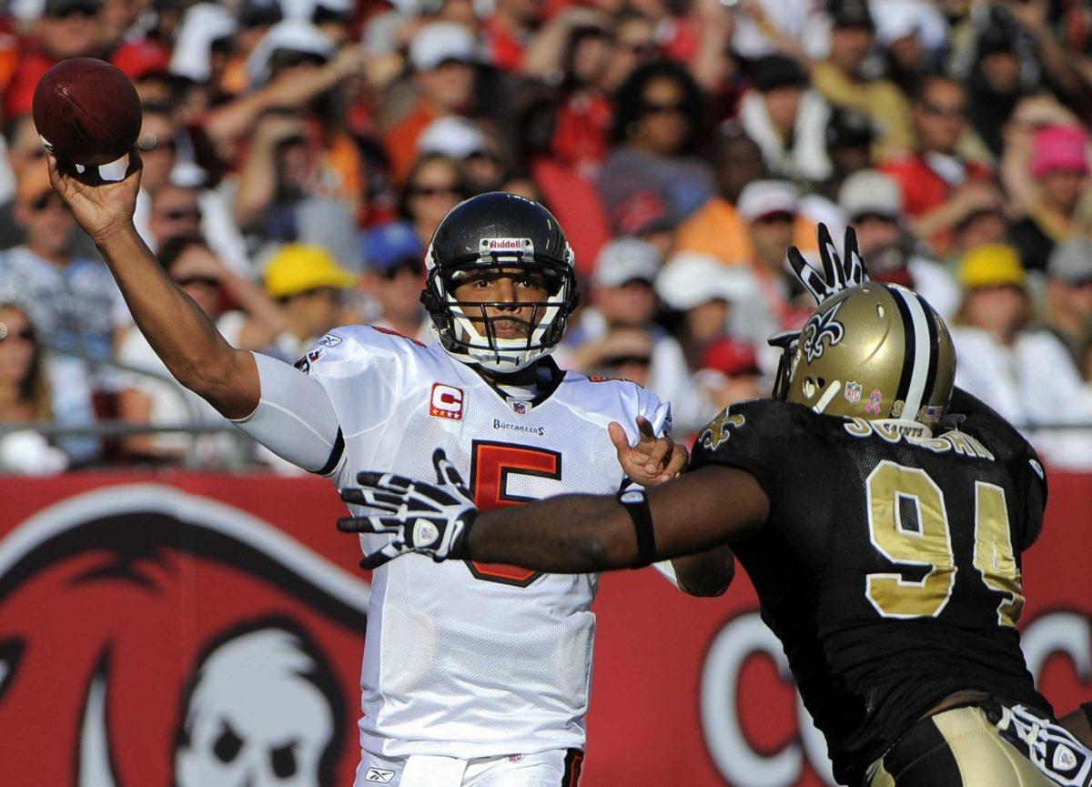 Tampa Bay Buccaneers quarterback Josh Freeman (5) fires a pass as New Orleans Saints defensive end Cameron Jordan (94) pressures him during the game Sunday.