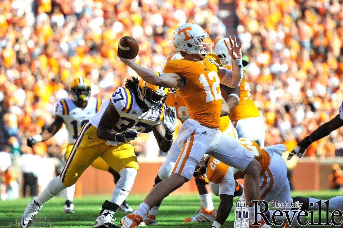 Senior linebacker Karnell Hatcher (37) rushes senior quarterback Matt Simms on Saturday during the Tigers' win.