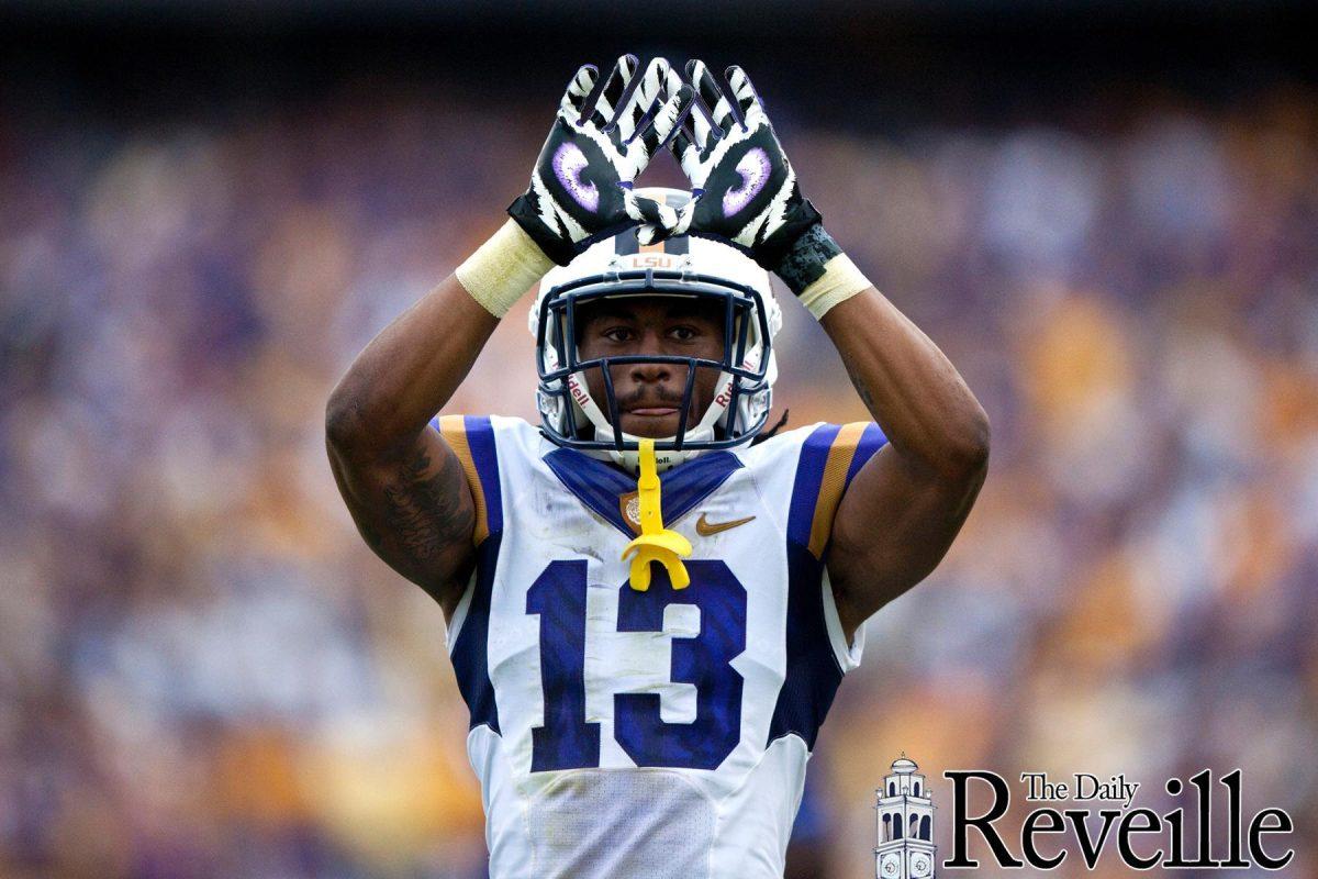 LSU senior cornerback Ron Brooks (13) shows off his Nike Pro Combat gloves during LSU&#8217;s 45-10 victory against Auburn on Saturday at Tiger Stadium.