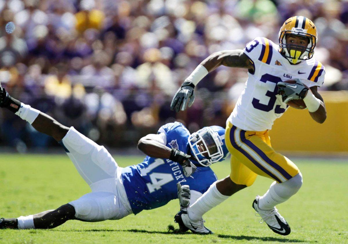 LSU wide receiver Odell Beckham Jr. (33) breaks away from Kentucky cornerback Anthony Mosley (14) and runs for a touchdown Saturday, Oct. 1, during the first quarter of an NCAA college football game in Tiger Stadium.