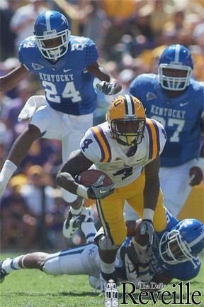 LSU sophomore running back Alfred Blue escapes University of Kentucky defenders Saturday during the game.