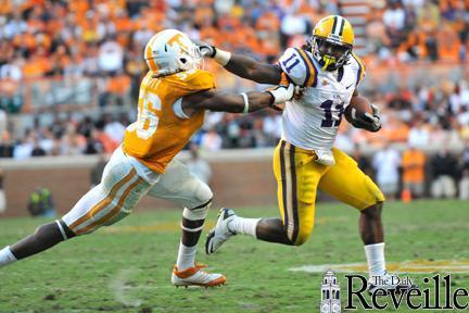 LSU sophomore running back Spencer Ware (11) stiff-arms Tennessee freshman defensive lineman Curt Maggitt (56) during Saturday&#8217;s matchup against the Volunteers.