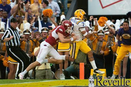 LSU sophomore defensive back Tyrann Mathieu (7) crosses the end zone after running a 92-yard punt return Friday in the Tigers&#8217; 41-17 win against Arkansas.