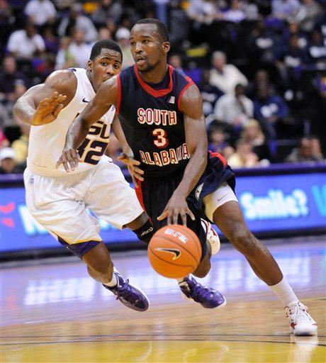 South Alabama's Xavier Roberson, right, drives around LSU's John Isaac, left, during an NCAA college basketball game, Wednesday, Nov. 23, 2011, in Baton Rouge, La. South Alabama won 79-75 in overtime. (AP Photo/The Advocate, Adam Lau)