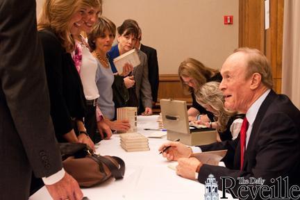 Dale Brown (right), former LSU basketball coach, signs books Wednesday for the release of his new book &#8220;Getting Over the 4 Hurdles of Life&#8221; in the Lod Cook Alumni Center. The book is an inspirational book that talks about over coming four basic obstacles to obtain your dream.