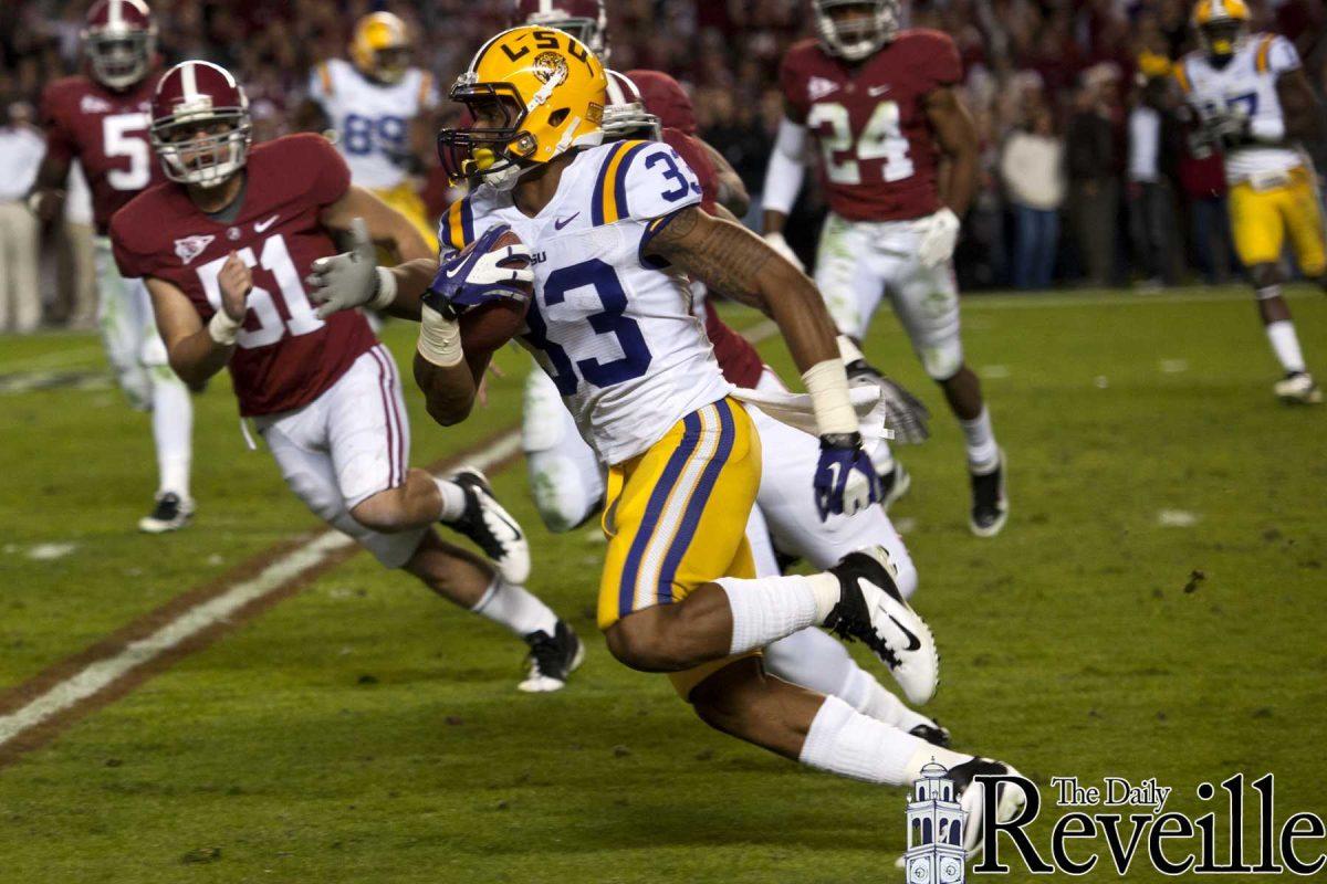 LSU wide receiver Odell Beckham Jr. (33) runs past Alabama defenders during a kick return during the Tigers' 9-6 victory against the Crimson Tide Saturday, Nov. 5, 2011, at Bryant-Denny Stadium in Tuscaloosa, Ala.