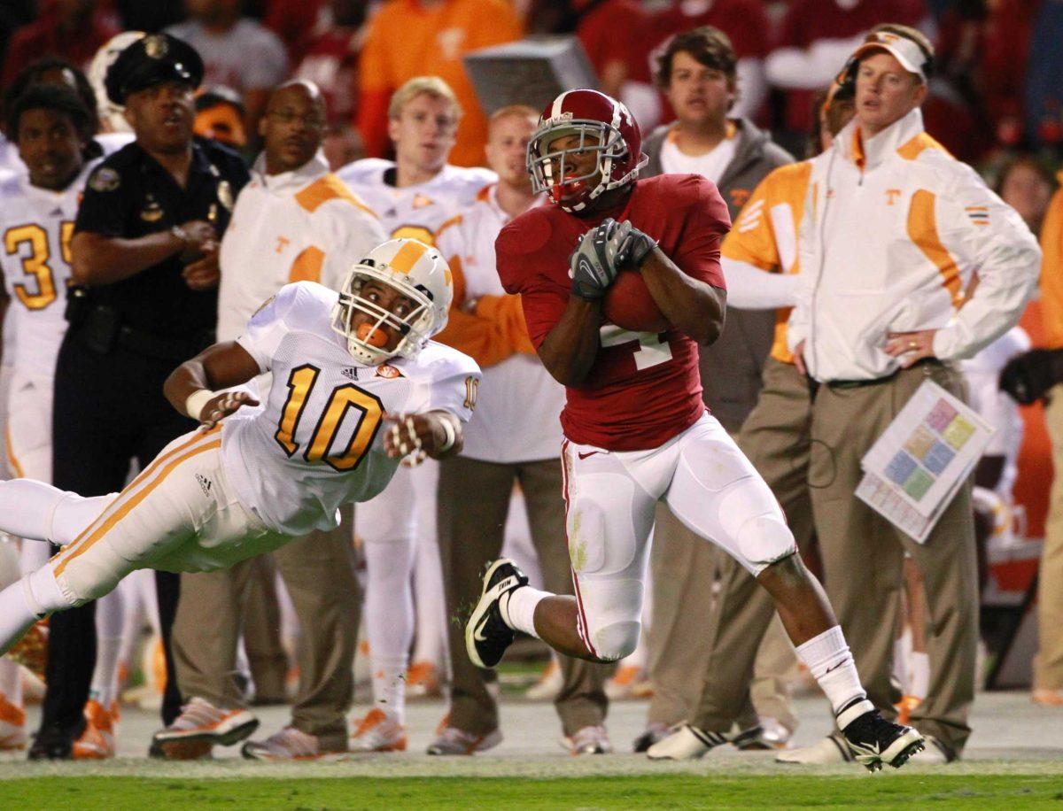 Alabama wide receiver Marquis Maze (4) hauls in a pass as Tennessee defensive back Marsalis Teague (10) watches during the first quarter of an NCAA college football game Saturday, Oct. 22, 2011, in Tuscaloosa, Ala.