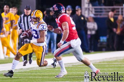 LSU freshman wide receiver Odell Beckham Jr. (33) tries to evade an Ole Miss defender Saturday in the Tigers&#8217; 52-3 win.