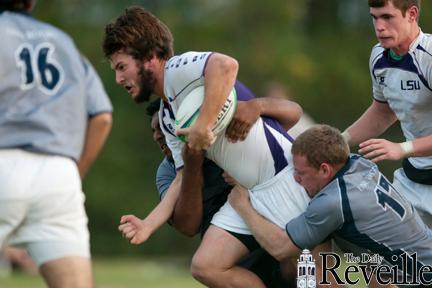 An LSU rugby player fights off University of New Orleans defenders in Saturday&#8217;s match. The Tigers won, 58-5.