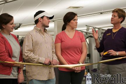 Student body President Cody Wells (middle left), Student body Vice President Kathleen Bordelon (middle right), and Speaker Pro Temp Abbey Vaughn (left) listen intently as UREC Director Laurie Braden (right) says a few words about the new UREC equipment.