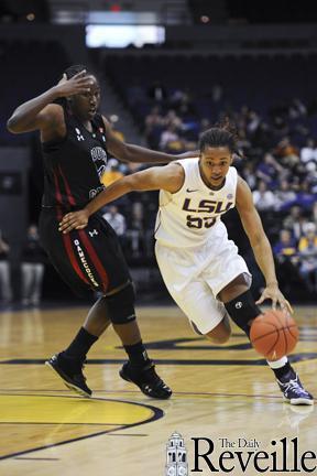 LSU senior forward LaSondra Barrett (55) drives past a South Carolina defender Jan. 12 in the Tigers&#8217; 58-48 victory against the Gamecocks in the PMAC.