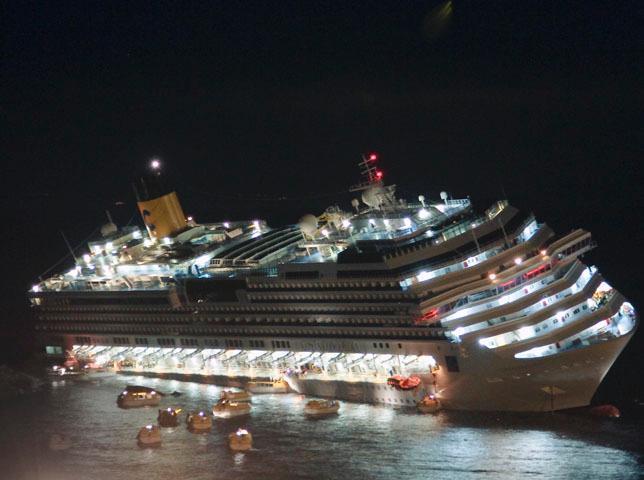 In this picture taken on Friday, Jan. 13, 2012 and made available on Wednesday, Jan. 25, 2012, the luxury cruise ship Costa Concordia lays on its starboard side after it ran aground off the coast of the Isola del Giglio island, Italy, gashing open the hull and forcing some 4,200 people aboard to evacuate aboard lifeboats to the nearby Isola del Giglio island. About 1,000 Italian passengers were onboard, as well as more than 500 Germans, about 160 French and about 1,000 crew members.