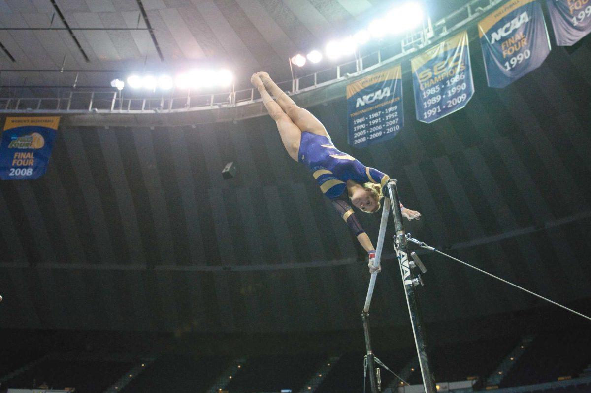 Sarie Morrison performs on bars, earning a career high of 9.925 to win the event title. The team went on to win the 2011 home finale over New Hampshire.