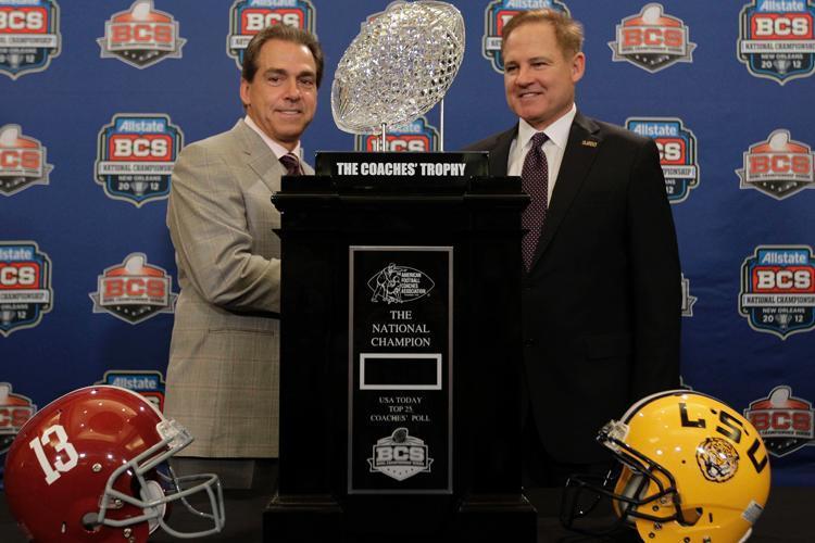 LSU head coach Les Miles, right, poses for a picture with Alabama head coach Nick Saban during a news conferemce for the BCS National Championship college football game Sunday, Jan. 8, 2012, in New Orleans.