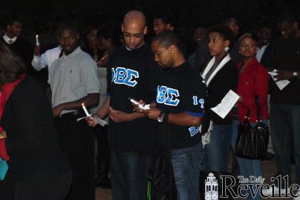 Members of Phi Beta Sigma fraternity attend a Martin Luther King Jr. candlelight vigil Monday at Memorial Tower.