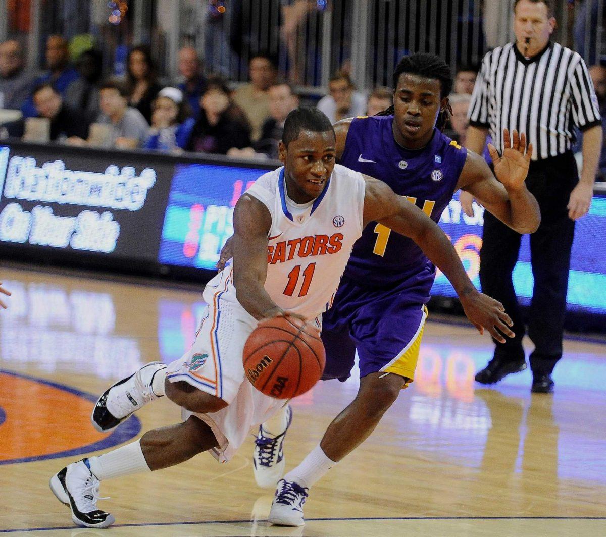 LSU freshman guard Anthony Hickey (1) tries to check Florida player Erving Walker&#8217;s (11) charge for the basket Saturday during LSU&#8217;s 76-64 loss in Gainesville, Fla.