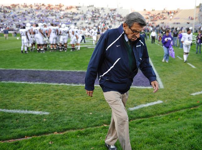 In this file photo taken Oct. 22, 2011, Penn State coach Joe Paterno walks off the field after warmups before Penn State's NCAA college football game against Northwestern in Evanston, Ill. Paterno, the longtime Penn State coach who won more games than anyone else in major college football but was fired amid a child sex abuse scandal that scarred his reputation for winning with integrity, died Sunday, Jan. 22, 2012. He was 85.