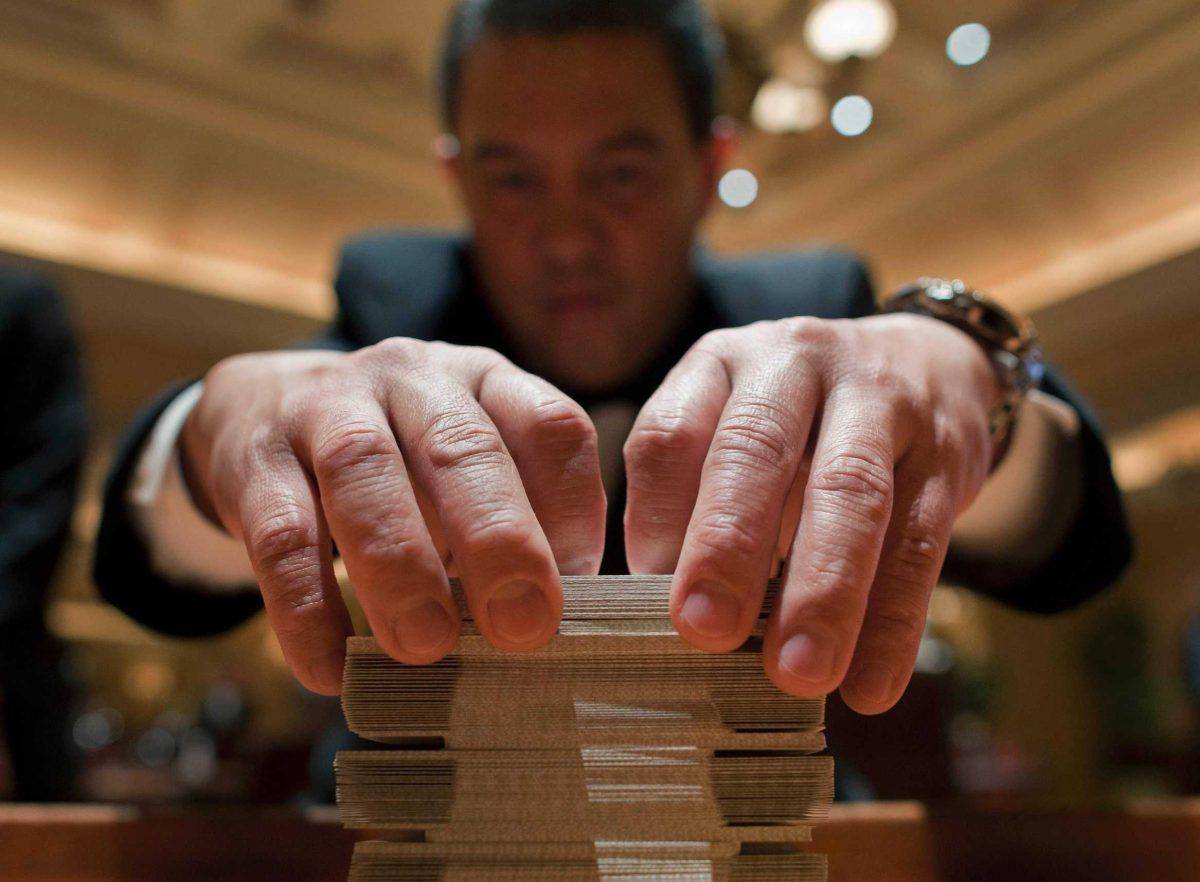 Baccarat dealer Ramiro Nepomuceno shuffles cards Wednesday at the MGM Hotel and Casino in Las Vegas.