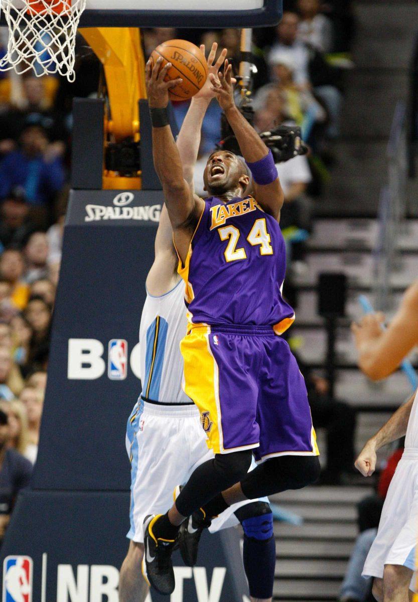 Los Angeles Lakers guard Kobe Bryant (24) goes up for a reverse against the Denver Nuggets during the third quarter of an NBA basketball game, Friday, Feb. 3, 2012, in Denver.