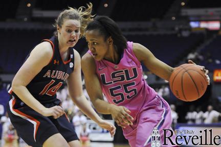 LSU senior forward LaSondra Barrett (55) drives past an Auburn defender Sunday during LSU&#8217;s 57-41 victory against Auburn in the PMAC.