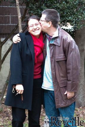 Chemistry professor Robert Cook plants a kiss on the cheek of his wife of nearly two decades, chemistry instructor Elzbieta Cook, on Monday.