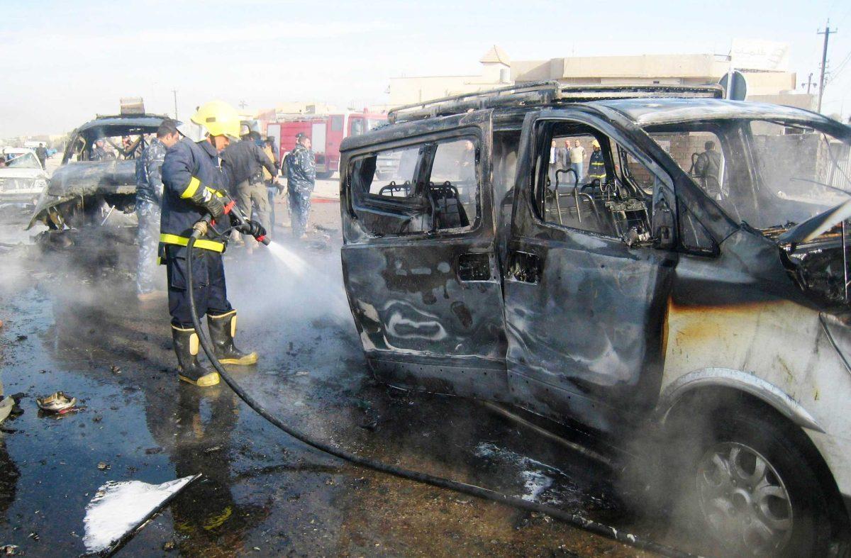 An Iraqi firefighter hoses down a burned bus Feb. 23 after a car bomb attack in Kirkuk, north of Baghdad, Iraq.